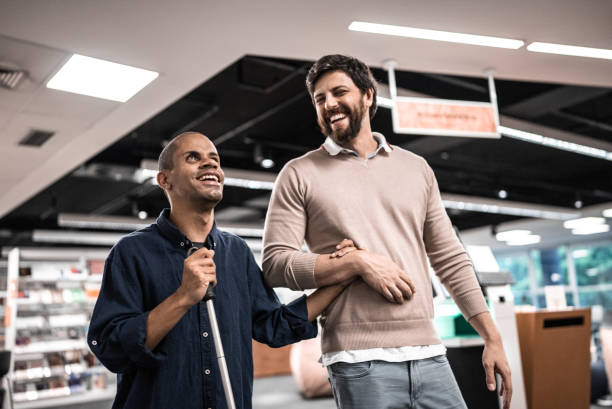 Man helping blind man walk